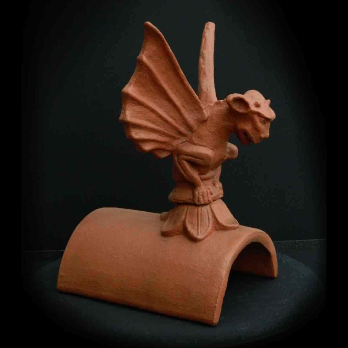 gargoyle sculpture on ridge tile